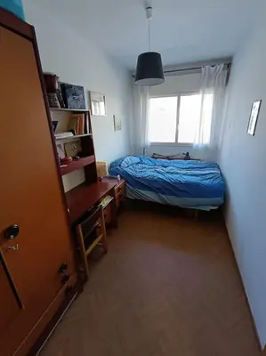 a small bedroom with a bed and a window at Mira a Parque in Lugo