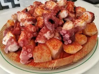 a plate of food with shrimp and grapes on it at Hostal Monteclaro in Ponferrada