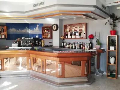 a bar with a wooden counter in a room at Hostal Monteclaro in Ponferrada