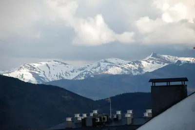 a view of snow covered mountains in the distance at Hostal Monteclaro in Ponferrada