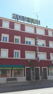 a red building with a sign on top of it at Hostal Monteclaro in Ponferrada