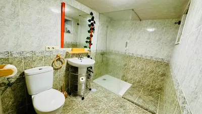 a bathroom with a toilet and a sink at Casa a Voada - Rural con Piscina Privada, Barbacoa y Juegos in Muiños
