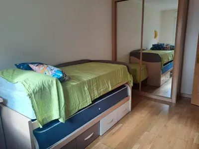 a bedroom with two beds and a mirror at EnFOZ PLAYA PISCINA Y PARKING in Foz