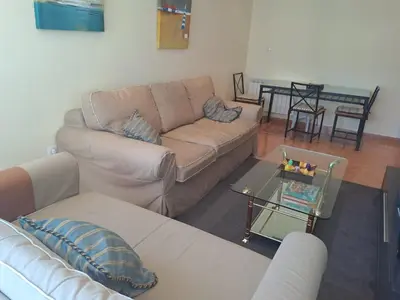 a living room with a couch and a table at EnFOZ PLAYA PISCINA Y PARKING in Foz