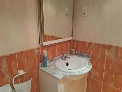 a bathroom with a sink and a mirror at EnFOZ PLAYA PISCINA Y PARKING in Foz