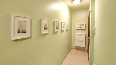 a hallway with pictures on the walls of a bathroom at Apartamento con wifi en casco histórico Betanzos in Betanzos