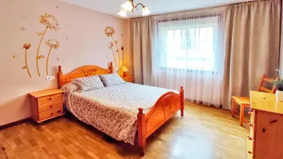 a bedroom with a wooden bed and a window at Apartamento con wifi en casco histórico Betanzos in Betanzos