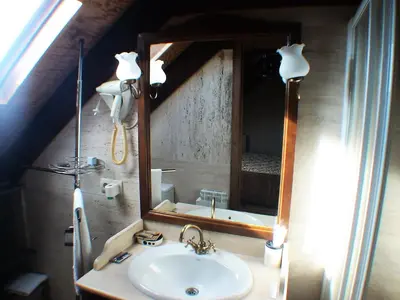 a bathroom with a sink and a mirror at Casa del Cura in Rozas