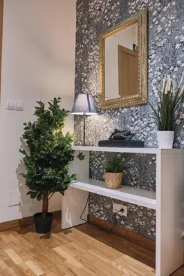 a room with a table with a mirror and a potted plant at Pensión A Solaina in O Pedrouzo