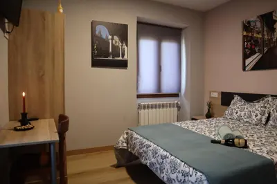 a bedroom with a bed and a candle on a table at Casa-Museo Genia Trigo in Sober