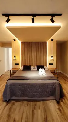 a bedroom with a large bed with two towels on it at Apartamento en el casco historico de Betanzos in Betanzos