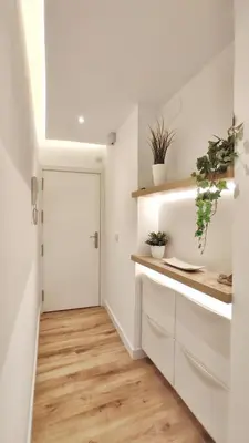 a kitchen with white cabinets and a door with plants at Apartamento en el casco historico de Betanzos in Betanzos
