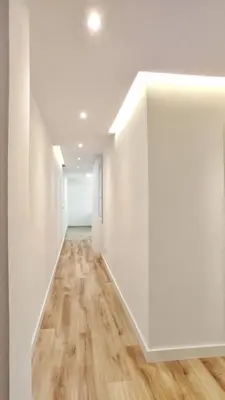 an empty hallway with white walls and wood floors at Apartamento en el casco historico de Betanzos in Betanzos