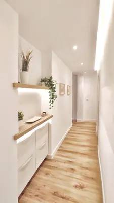 an empty hallway with white walls and wood floors at Apartamento en el casco historico de Betanzos in Betanzos