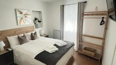 a bedroom with a bed with towels on it at Casa Mencía in Camponaraya