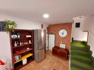 a room with a staircase and a brick wall at Casa Mencía in Camponaraya
