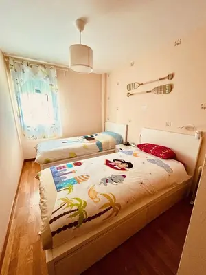 a bedroom with two beds and a window at Apartamento de Begoña in Barreiros