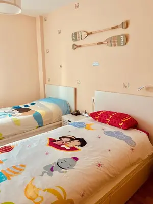 a bedroom with two beds with hello kitty sheets at Apartamento de Begoña in Barreiros
