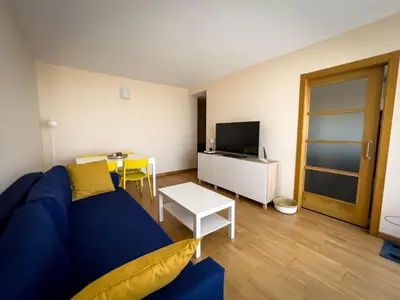a living room with a blue couch and a table at Apartamento de Begoña in Barreiros