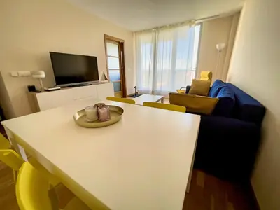 a living room with a white table and a couch at Apartamento de Begoña in Barreiros