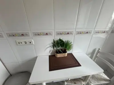 a white table with a potted plant on it at Oktheway Fonteculler in Culleredo