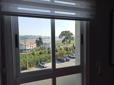 a window with a view of a parking lot at Oktheway Fonteculler in Culleredo