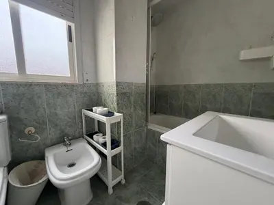 a bathroom with a white toilet and a sink at Oktheway Fonteculler in Culleredo