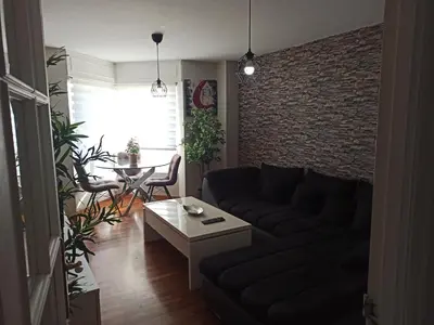 a living room with a couch and a brick wall at Oktheway Fonteculler in Culleredo