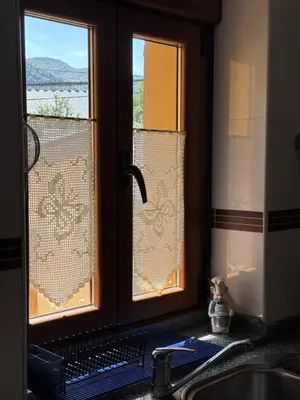 a kitchen with a sink and a window with a view at La Casucha in Caboalles de Abajo