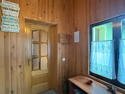 a wooden room with a door and a window at La Casucha in Caboalles de Abajo