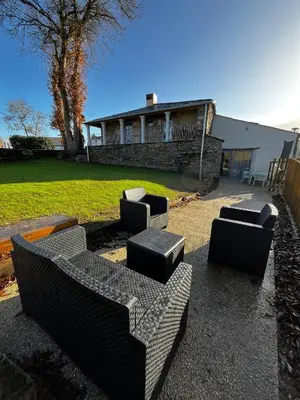 a group of couches sitting in front of a house at HOTEL CASAS DA FORTALEZA Casa da Torre in Outeiro de Rei
