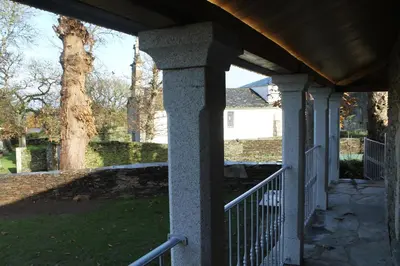 a porch of a house with a fence and a tree at HOTEL CASAS DA FORTALEZA Casa da Torre in Outeiro de Rei