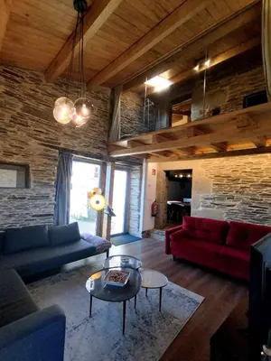 a living room with a couch and a table at HOTEL CASAS DA FORTALEZA Casa da Torre in Outeiro de Rei