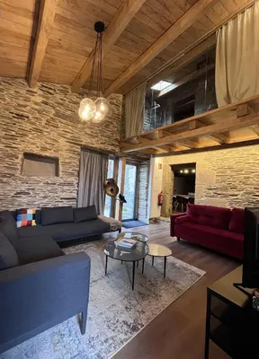 a living room with couches and a brick wall at HOTEL CASAS DA FORTALEZA Casa da Torre in Outeiro de Rei