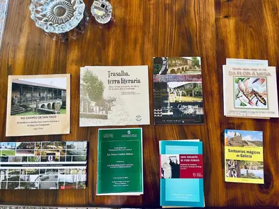a table with a bunch of brochures on it at O Souto de Monteasnal in Ourense