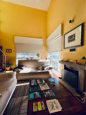 a yellow room with a bed and a fireplace at O Souto de Monteasnal in Ourense