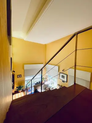 a staircase in a house with a yellow wall at O Souto de Monteasnal in Ourense