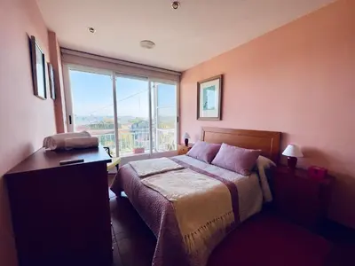 a bedroom with a bed and a large window at O Souto de Monteasnal in Ourense