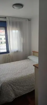 a bedroom with two beds and a window at Ciudad De Sada in Sada