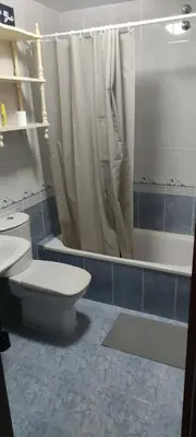 a bathroom with a toilet and a shower and a tub at Ciudad De Sada in Sada