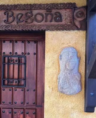 a stone statue on the side of a building at Casa Begoña in Igüeña