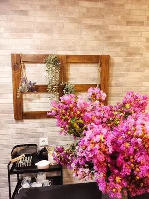 a bunch of pink flowers hanging from a wall at Casa rústica O NOSO VAL in Mondariz