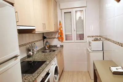a small kitchen with a sink and a microwave at Apartamento en el centro de FOZ in Foz