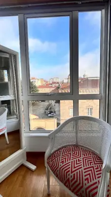 a white chair sitting in front of a large window at Apartamentos San Martin Ourense Centro 2 in Ourense