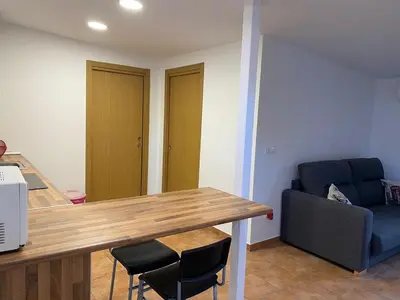 a kitchen with a table and chairs and a couch at Apartamento Sant-Yago in Santiago de Compostela