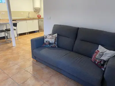 a blue couch with two pillows on it in a living room at Apartamento Sant-Yago in Santiago de Compostela