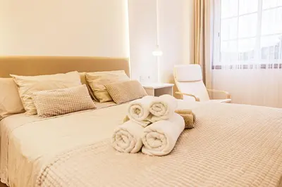 a bedroom with a bed with towels on it at Apartamento completo con wifi en Betanzos in Betanzos