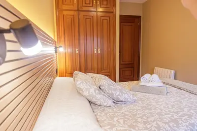 a bedroom with a bed with two pillows on it at Apartamento completo con wifi en Betanzos in Betanzos
