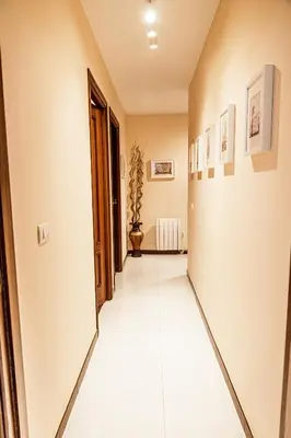 a hallway with white tile flooring in a house at Apartamento completo con wifi en Betanzos in Betanzos