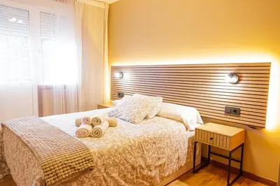 a bedroom with a bed with two towels on it at Apartamento completo con wifi en Betanzos in Betanzos